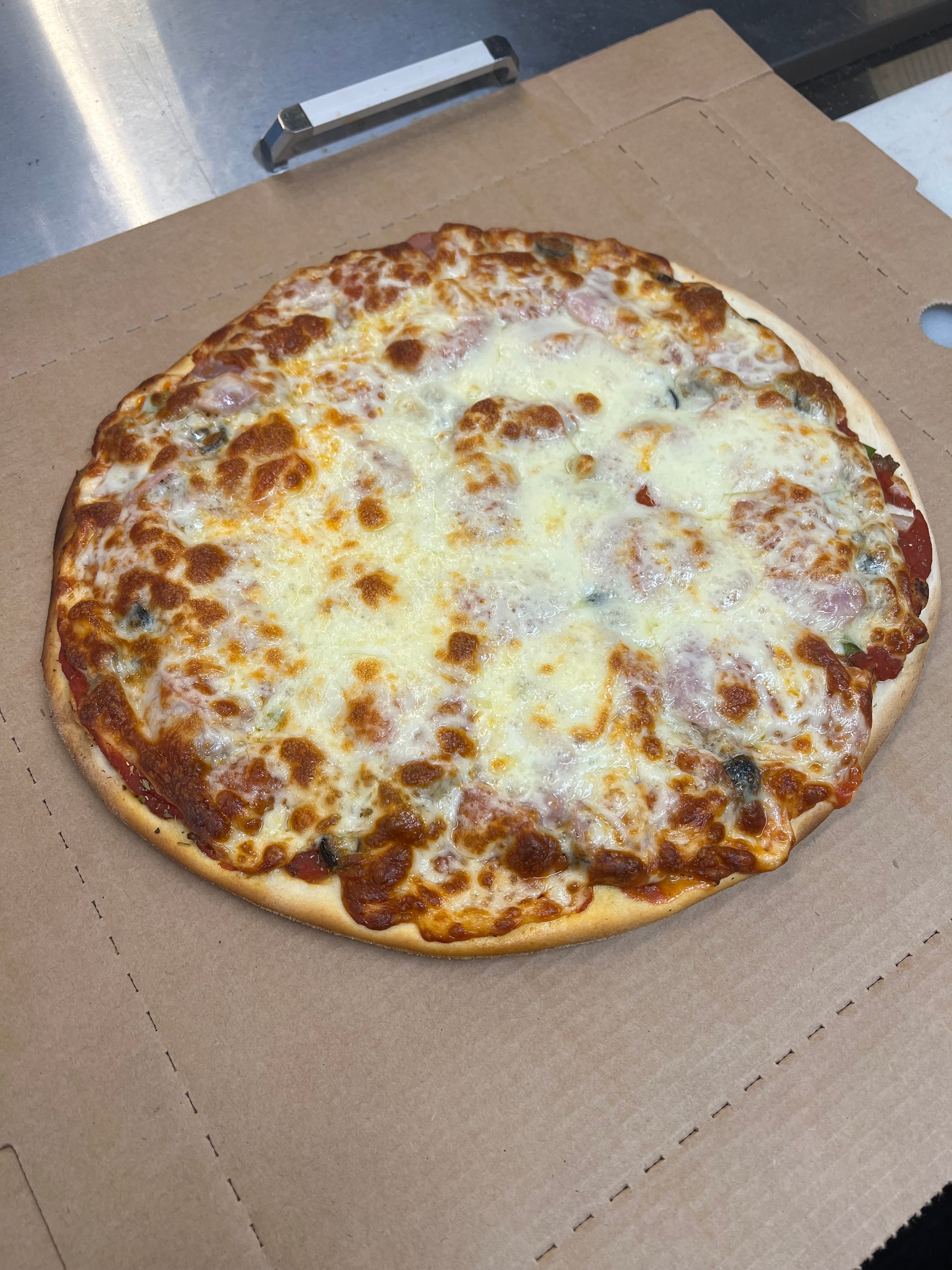 Baked pizza with cheese and meat toppings