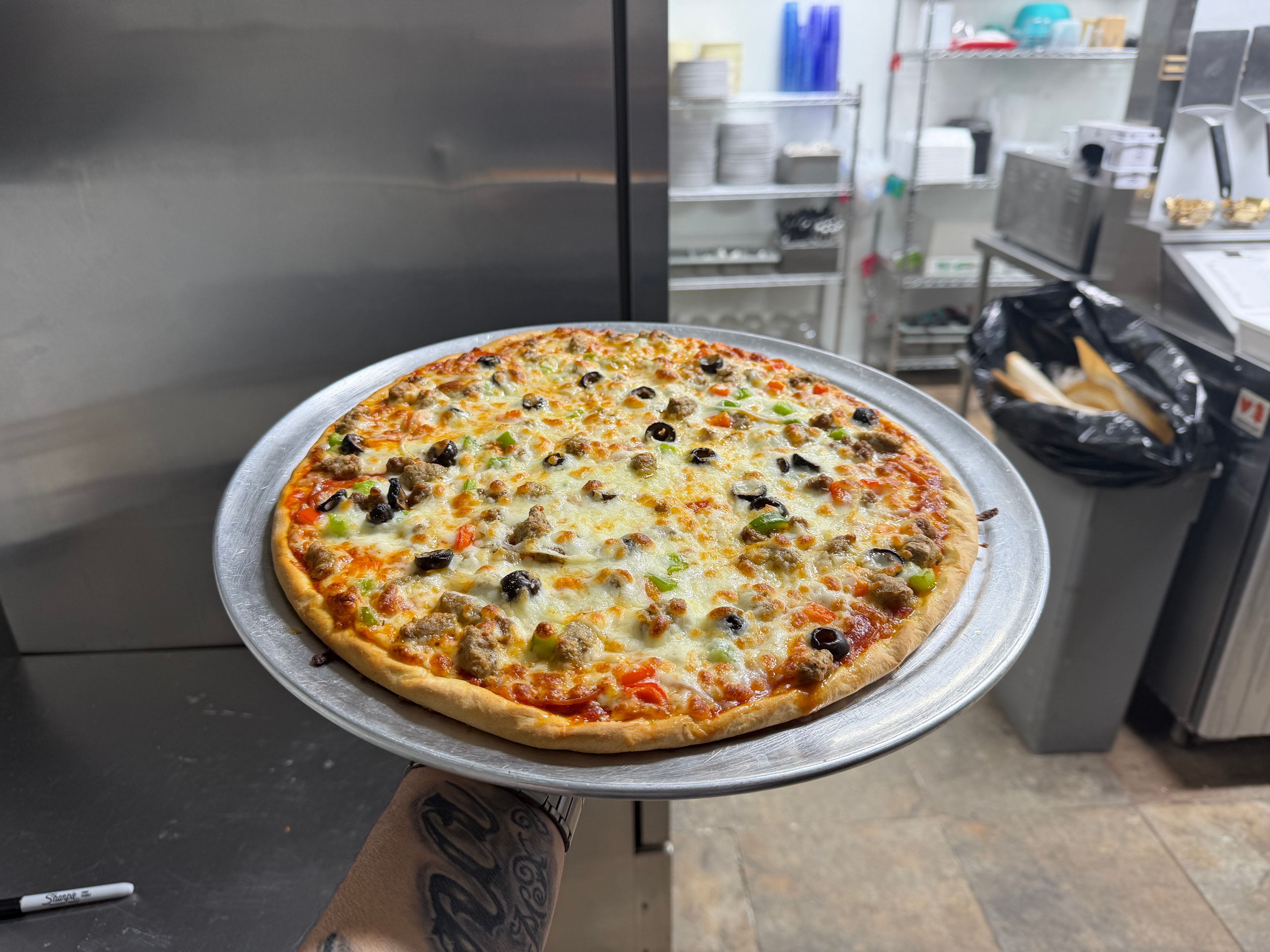 Freshly baked pizza with meat and olives